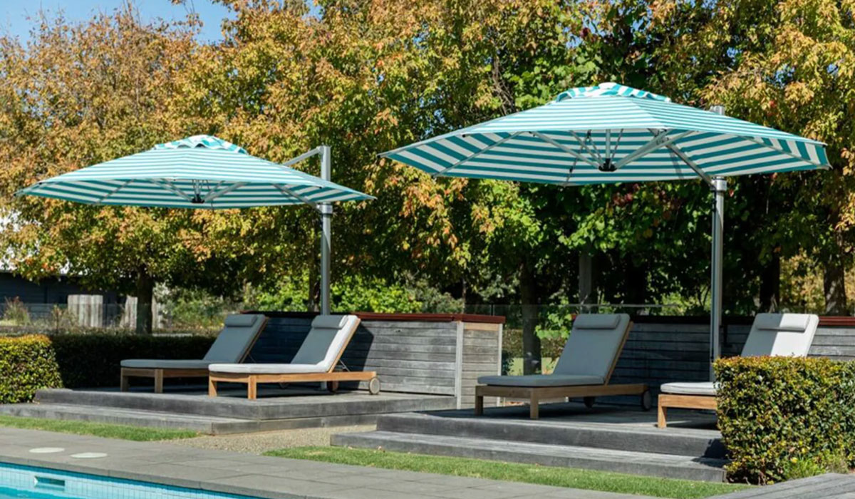 Two Instashade cantilever parasols side by side proving shade to garden deck chairs